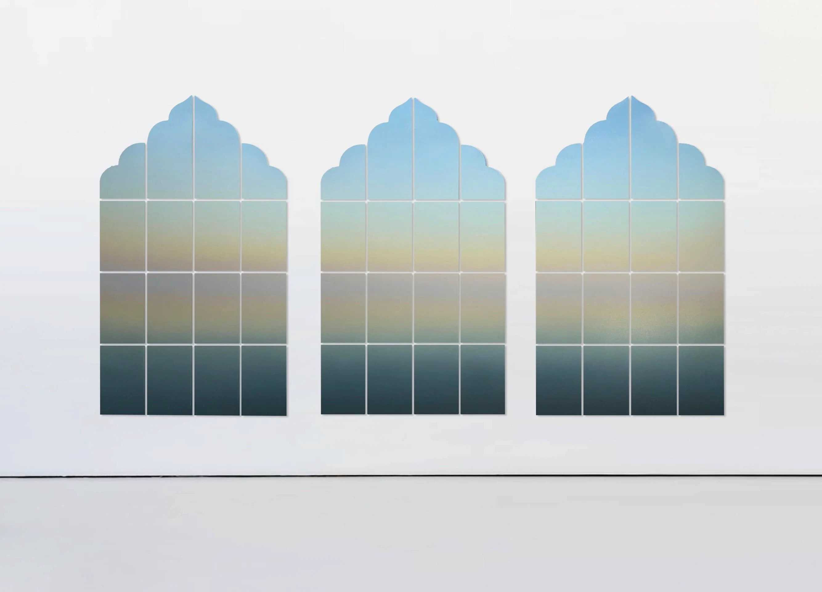 Three arched panels in the shape of temple windows, gridded into panes, each holding the same pale blue-to-teal gradient.