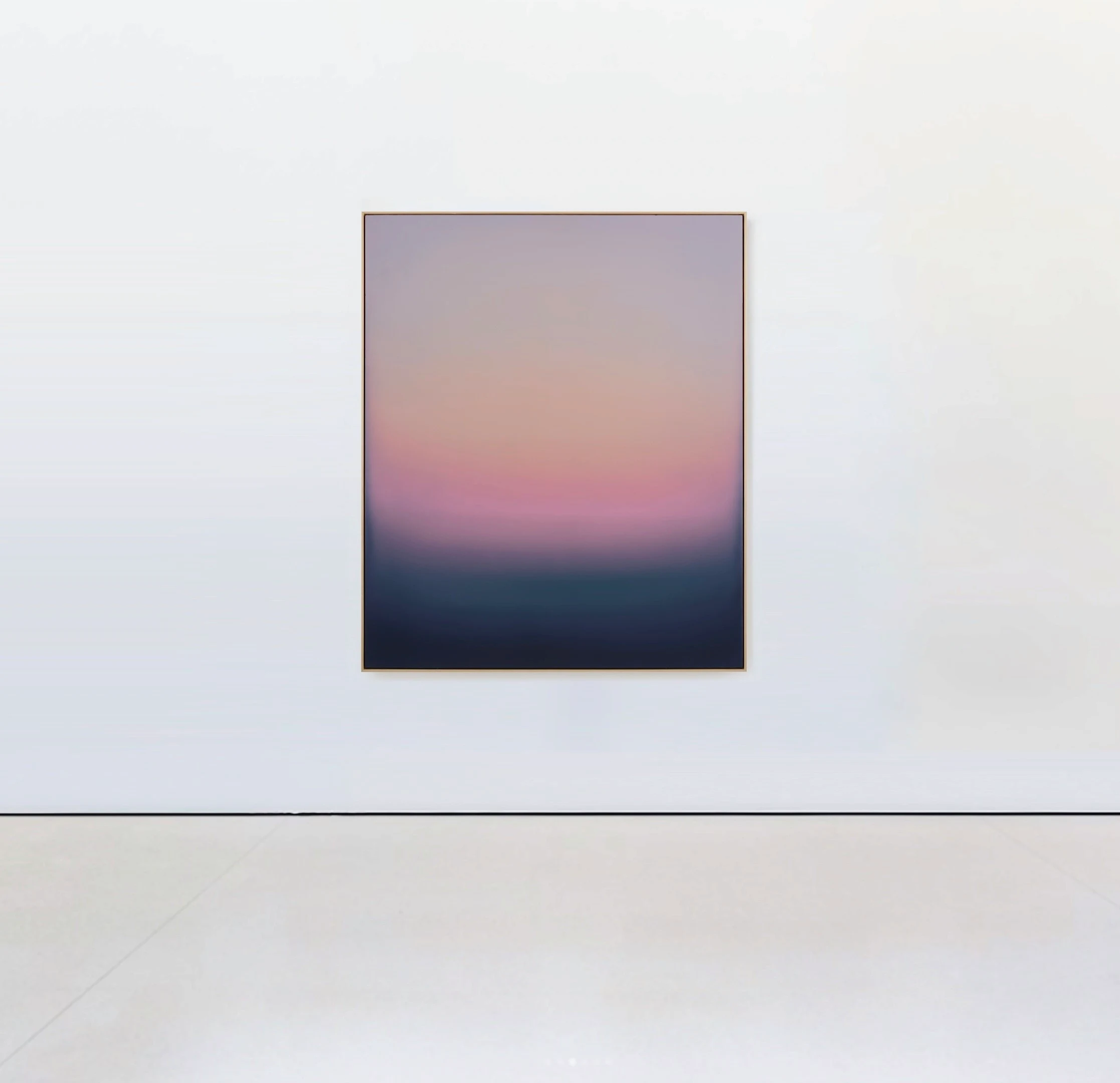 A framed painting where grey-lilac sky warms into a band of pink and orange before dropping into dark blue-green.
